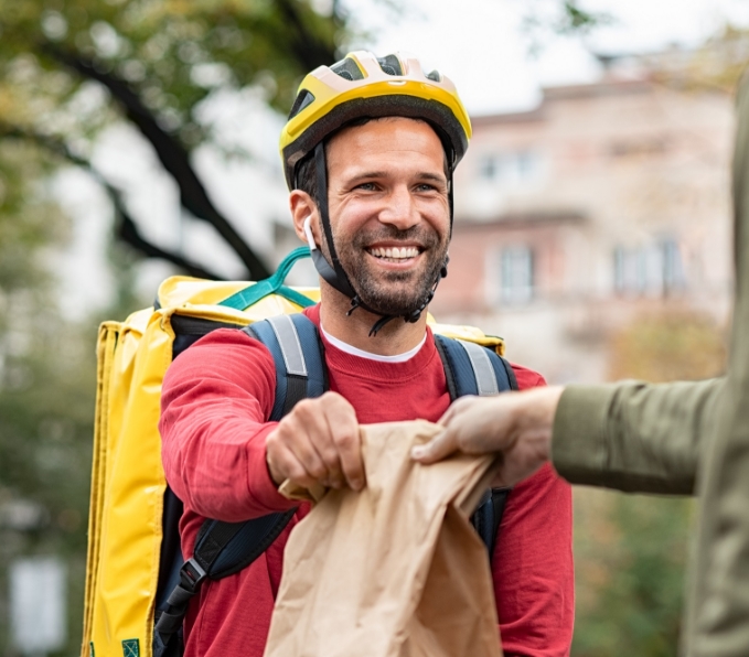 delivery-man-giving-take-away-food-DBXUQTG.jpg